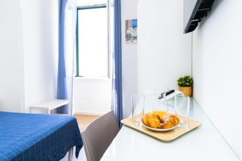 a plate of donuts on a table in a room at FRENNESIA Amalfi Coast in Atrani