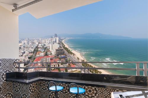 a balcony with a view of the beach and buildings at Modern Seaview Apt next to Walking St & My An Beach in Da Nang