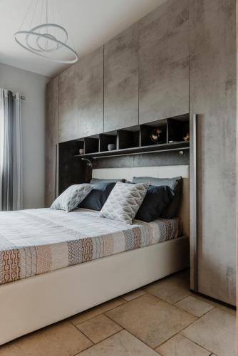 a bedroom with a large bed with a large headboard at Trullo Della Murgia - Villa in Castel del Monte
