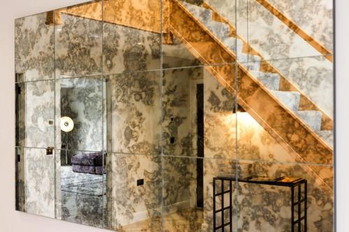 a bathroom with a staircase and a glass wall at Mylstone House in Blackburn