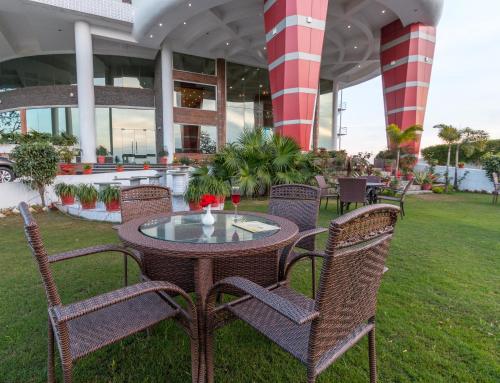 a table and chairs in front of a building at Pride Premier Solitaire in Dehradun