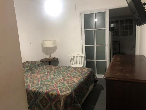 1 dormitorio con cama, escritorio y ventana en Mesonada en Federación