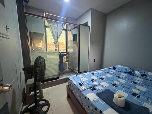 a bedroom with a large bed and a window at Adrian´s Hotel in Pucallpa