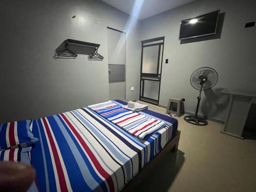 Ein Bett oder Betten in einem Zimmer der Unterkunft Adrian´s Hotel