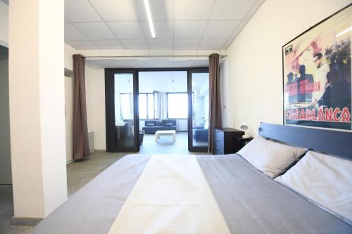 a bedroom with a bed and a living room at Da Zoe in Moncalvo