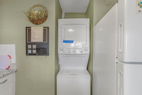 a washer and dryer in the corner of a kitchen at Sea Breeze 316 by Vacation Homes Collection in Gulf Shores