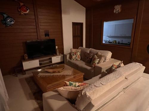 a living room with two couches and a flat screen tv at Potxi & Cabana in Guriú