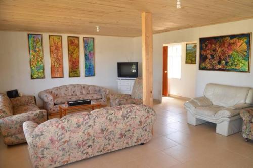 sala de estar con 2 sofás y TV en VILLA ERIKA comoda casa bellisima vista, en Paipa