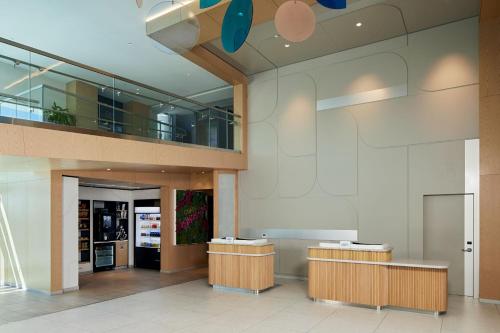 a lobby of a building with two reception desks at Courtyard by Marriott Santa Barbara Downtown in Santa Barbara