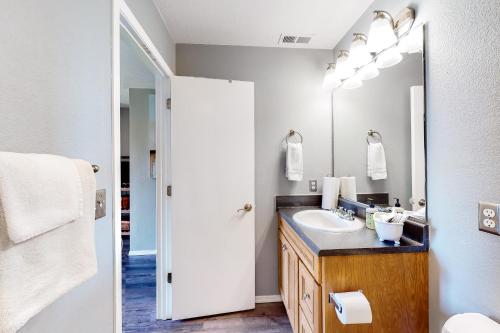 a bathroom with a sink and a mirror at Making Branson Memories - Unit 1 in Branson