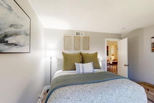 a bedroom with a bed with blue and green pillows at Riviera Gardens in Palm Springs