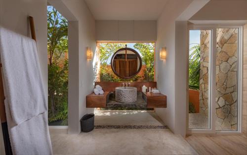a bathroom with a large mirror and a tub at Sayulinda Hotel in Sayulita