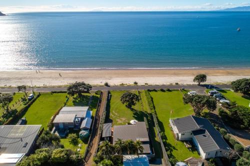 an aerial view of a house and the beach at Onetangi Beachfront Escape - Coast & Country in Onetangi