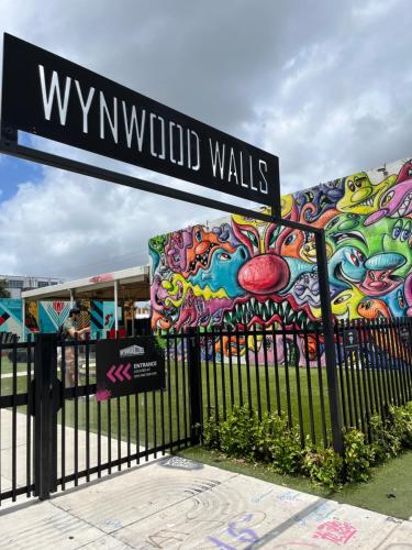 a street sign in front of a building with graffiti at Stunning Little Havana Suites Close to airport, Calle Ocho, Brickell, Wynwood and the Beaches - Free Parking in Miami
