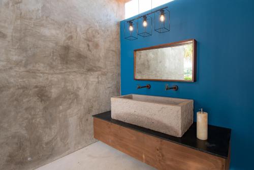a bathroom with a sink and a mirror at Sayulinda Hotel in Sayulita