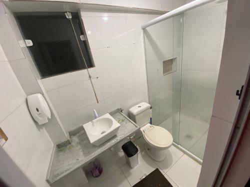 a bathroom with a toilet and a sink and a shower at THE BROTHERS in Angra dos Reis