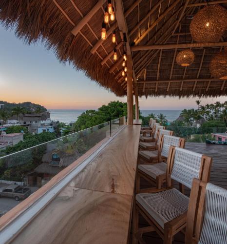 a bar with chairs and a view of the ocean at Sayulinda Hotel in Sayulita