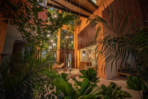 a large room with plants in a building at Sayulinda Hotel in Sayulita
