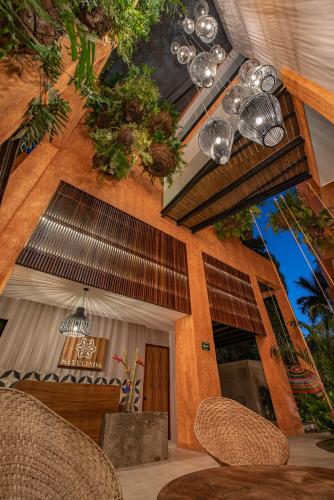 a patio with chairs and a building with plants at Sayulinda Hotel in Sayulita