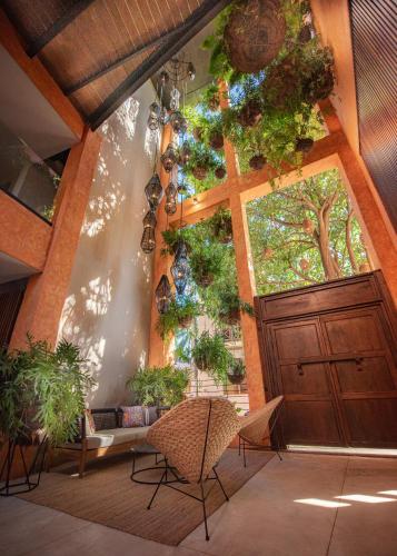 a room with a large wooden door and chairs at Sayulinda Hotel in Sayulita