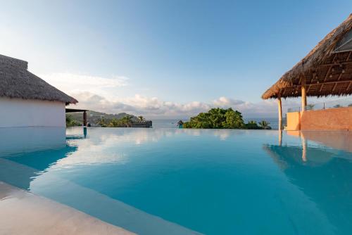a swimming pool with blue water next to a building at Sayulinda Hotel in Sayulita