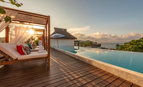 a room with a bed and a swimming pool at Sayulinda Hotel in Sayulita