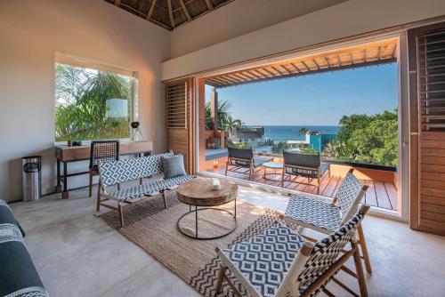 a living room with a view of the ocean at Sayulinda Hotel in Sayulita