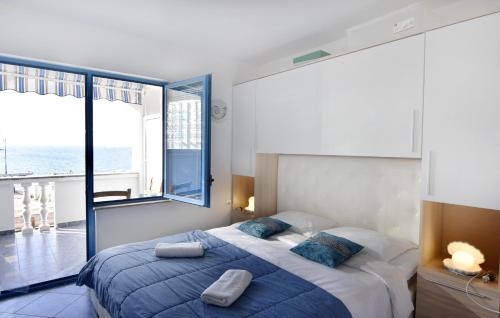 a bedroom with a large bed and a large window at Apartments by the sea Savudrija, Umag - 20295 in Savudrija