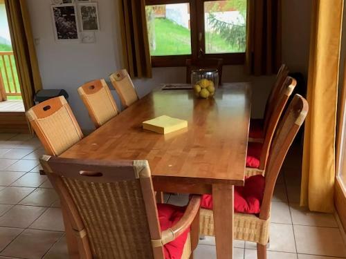a dining room table with chairs and a wooden table and chairsktop at Warm Chalet in Oz with Ski Storage Balcony Terrace Heating in Oz