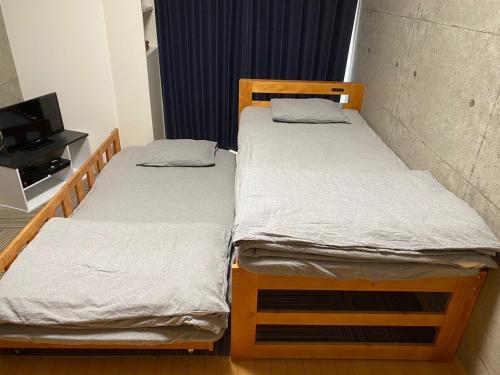 two bunk beds in a room with a tv at Marvelous Kokubunji - Vacation STAY 80468v in Kokubunji