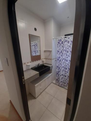 a bathroom with a sink and a mirror at Dpto Piacentini in Resistencia