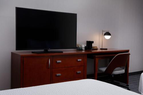 a television on a desk in a hotel room at Courtyard Denver Tech Center in Greenwood Village