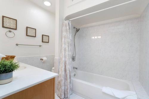 a white bathroom with a tub and a shower at Stunning 2BR w/ 1BA Home near BART in Daly City