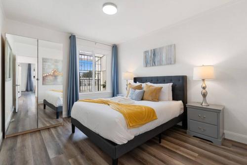 a bedroom with a large bed and a mirror at Stunning 2BR w/ 1BA Home near BART in Daly City