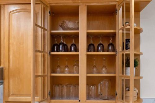 a wooden cabinet filled with lots of wine glasses at Stunning 2BR w/ 1BA Home near BART in Daly City