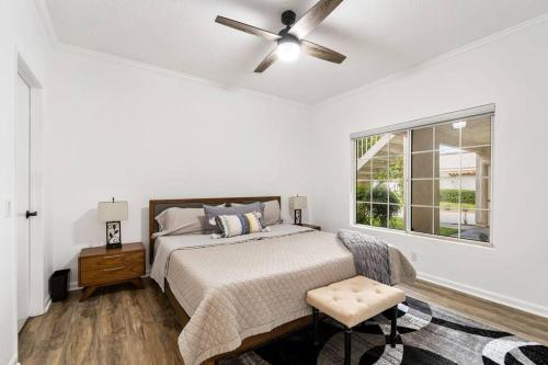 a white bedroom with a bed and a ceiling fan at Desert Falls Diamond - pool, spa, golf, views! in Palm Desert
