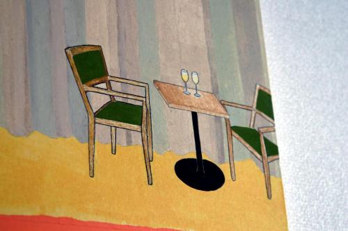 a painting of two chairs and a table with scissors at Oasis Wadaura in Minamiboso