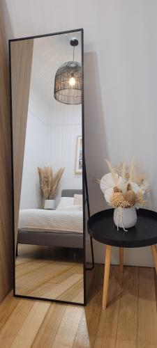 a mirror in a room with a table and a couch at Boutique Beach House in the HEART of St. Kilda in Melbourne