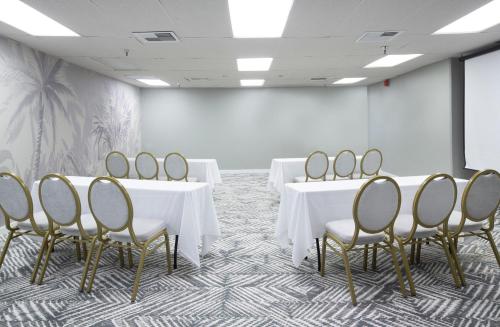 a conference room with white tables and chairs at The Twin Fin Hotel in Honolulu