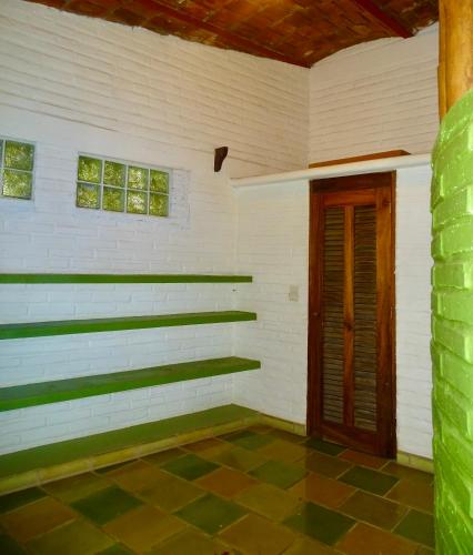 a room with white walls and a wooden door at Sayulita Beach House Hotel in Sayulita