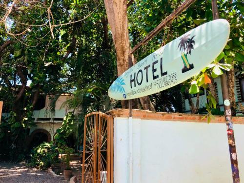 a sign for a hotel with a surfboard on it at Sayulita Beach House Hotel in Sayulita