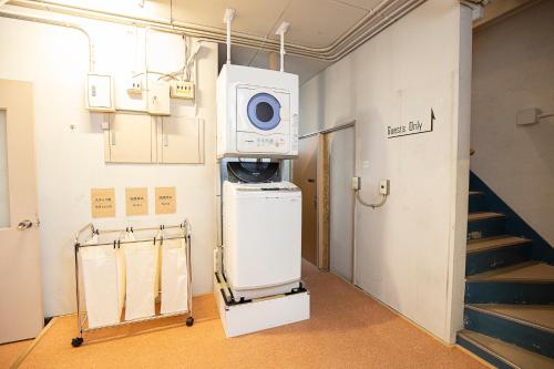 a room with a machine in a room with stairs at Guest House POST INN in Tenkawa