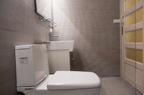 a bathroom with a white toilet and a sink at 如一家精緻民宿 in Jincheng