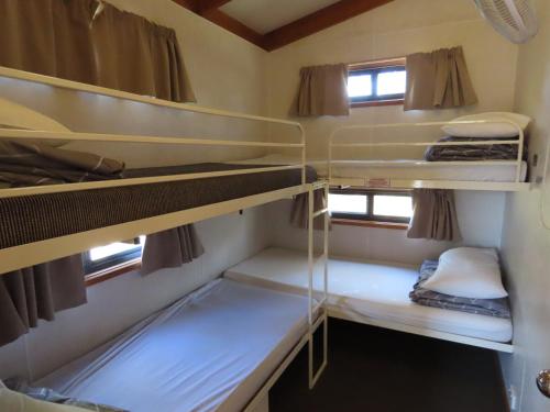 a small room with bunk beds in it at Albury Gardens Tourist Park in Lavington