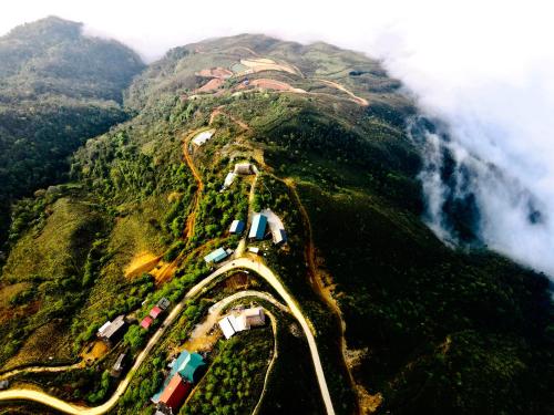 an aerial view of a mountain with a road on it at 1941M Homestay Tà Xùa in Bắc Yên