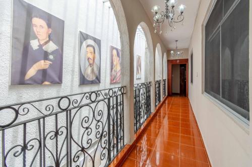 a hallway with paintings on the walls at Hostería Casa Marquez in León