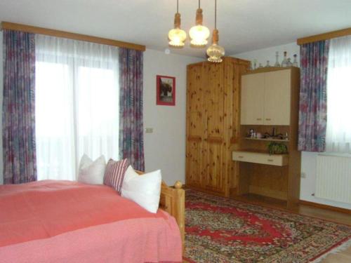 a bedroom with a bed with a red blanket at Charming holiday home in Gosau in Gosau