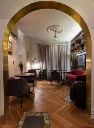 an archway in a room with tables and chairs at Aposento Boutique Hotel in Mexico City