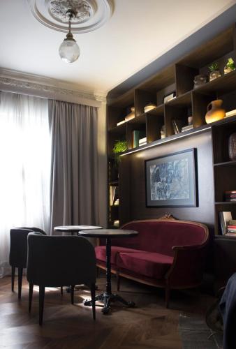 a living room with a table and a couch at Aposento Boutique Hotel in Mexico City