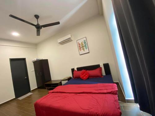 a bedroom with a red bed and a ceiling fan at SYG 8 Aura Suite Putrajaya Studio Unit in Putrajaya